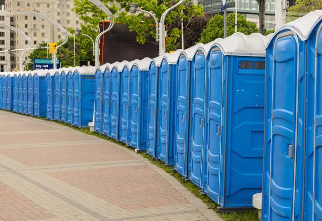 a line of portable restrooms at a sporting event, providing athletes and spectators with clean and accessible facilities in Aurora