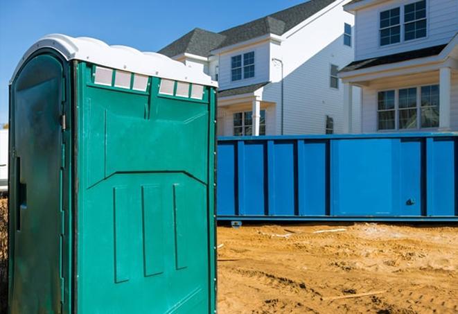 a row of portable toilets on a bustling work site